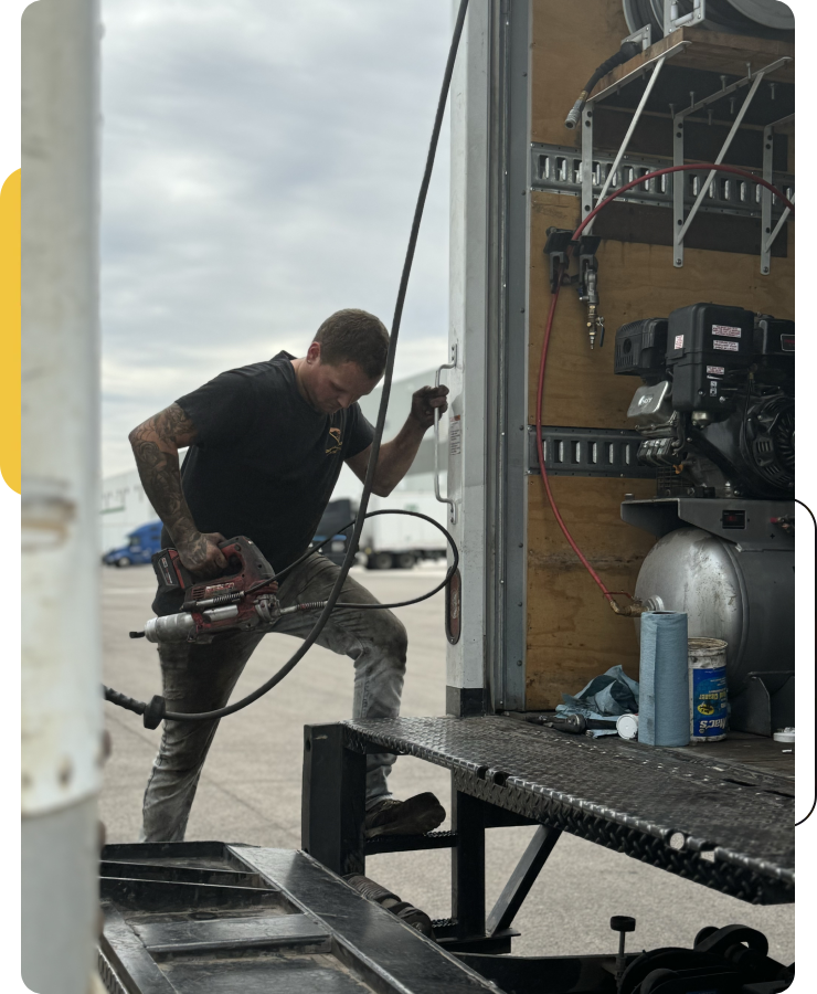 Mechanic working on truck equipment.