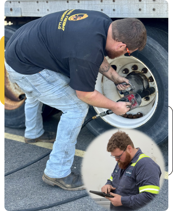 Mechanic repairing truck tire and using tablet.